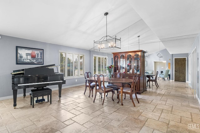 dining room featuring vaulted ceiling and a notable chandelier