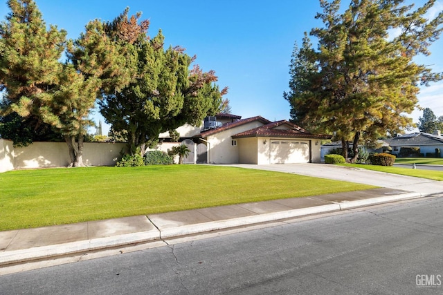 view of front of property with a garage and a front lawn