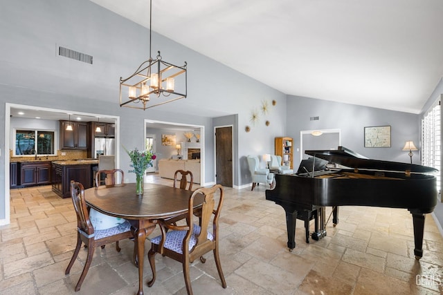 dining room with lofted ceiling and a chandelier