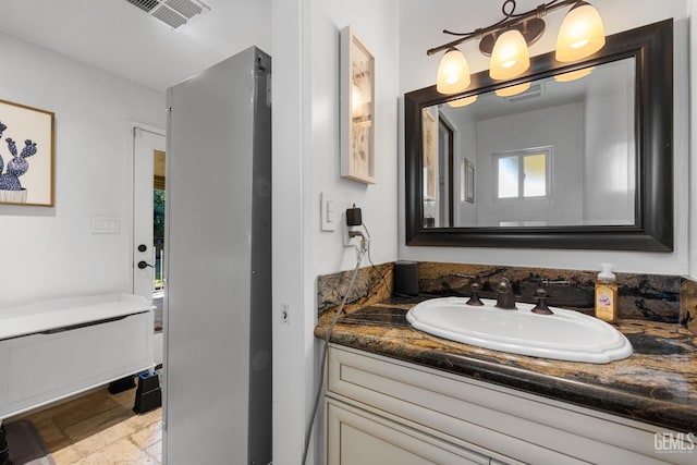 bathroom featuring vanity and a wealth of natural light