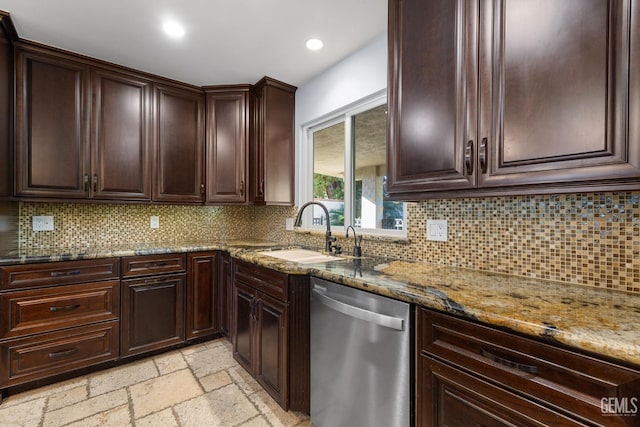 kitchen with backsplash, sink, stainless steel dishwasher, light stone counters, and dark brown cabinetry