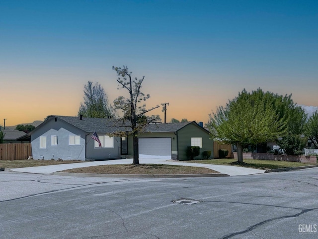 single story home featuring fence, driveway, and an attached garage
