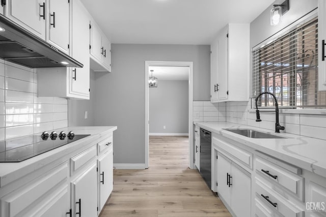 2848 Summit Cir, Bakersfield, CA 93306 - kitchen featuring under cabinet range hood, black appliances, a sink, and white cabinetry