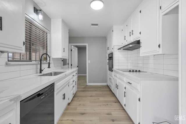 2848 Summit Cir, Bakersfield, CA 93306 - kitchen with black appliances, under cabinet range hood, a sink, light wood-style flooring, and white cabinets