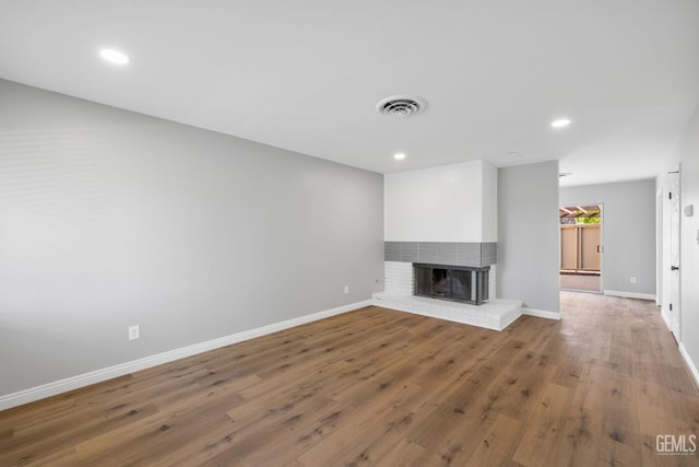 2848 Summit Cir, Bakersfield, CA 93306 - unfurnished living room featuring baseboards, wood finished floors, recessed lighting, and a brick fireplace