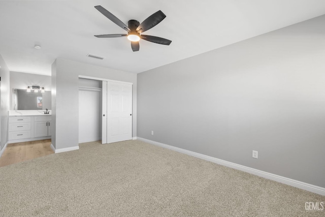 2848 Summit Cir, Bakersfield, CA 93306 - unfurnished bedroom with light carpet, a closet, baseboards, ensuite bath, and a sink