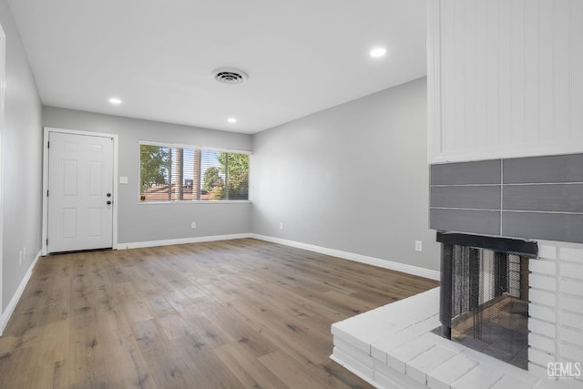 2848 Summit Cir, Bakersfield, CA 93306 - unfurnished living room with wood finished floors, a fireplace, baseboards, and recessed lighting