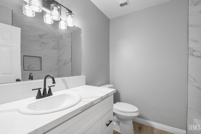 2848 Summit Cir, Bakersfield, CA 93306 - bathroom featuring toilet, vanity, wood finished floors, and baseboards