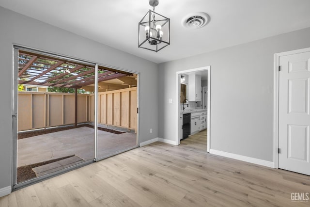 2848 Summit Cir, Bakersfield, CA 93306 - unfurnished dining area with baseboards, light wood-style flooring, a chandelier, and a sink