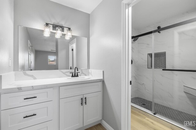 2848 Summit Cir, Bakersfield, CA 93306 - full bathroom with a marble finish shower, vanity, and wood finished floors