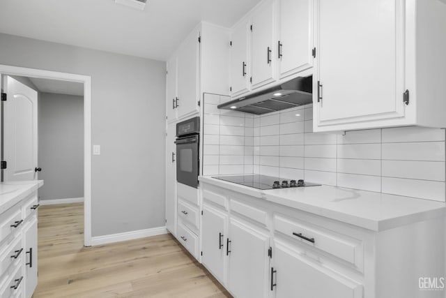 2848 Summit Cir, Bakersfield, CA 93306 - kitchen with black appliances, under cabinet range hood, decorative backsplash, white cabinetry, and light wood-style flooring