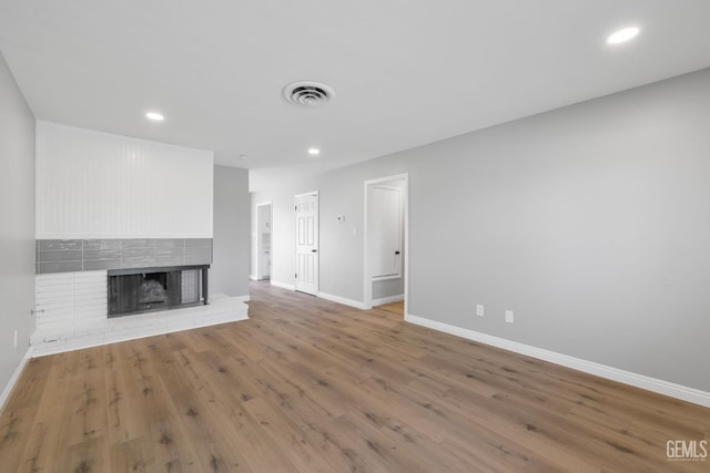 2848 Summit Cir, Bakersfield, CA 93306 - unfurnished living room with baseboards, a brick fireplace, wood finished floors, and recessed lighting