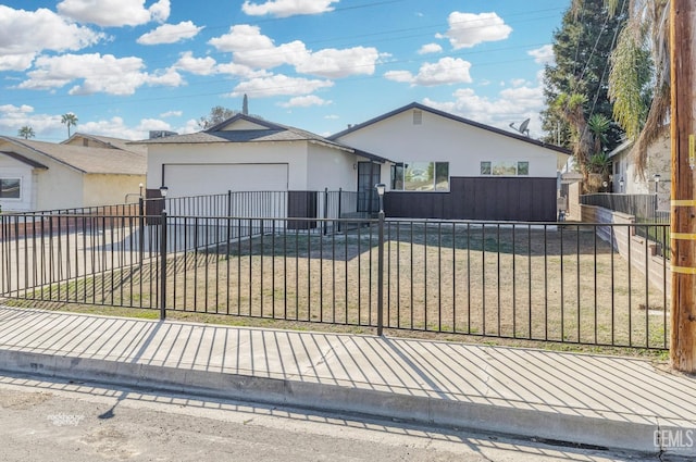 single story home featuring a garage and a front lawn