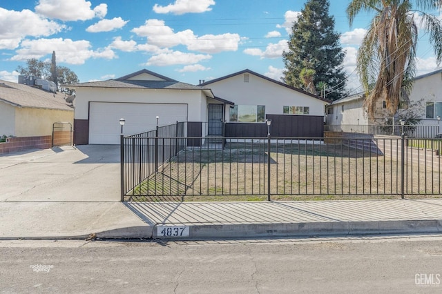 ranch-style house featuring a garage and a front lawn