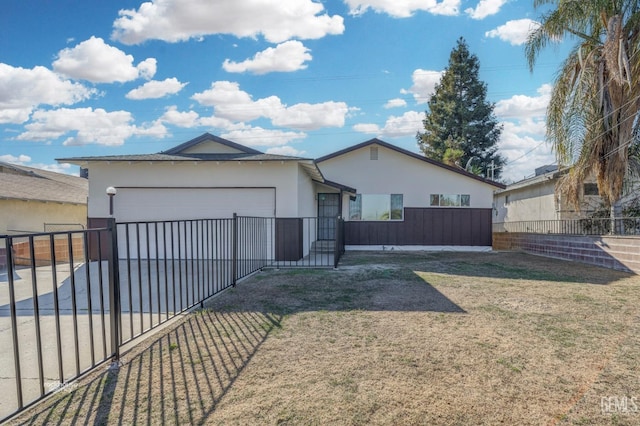 view of front of property with a garage and a front lawn