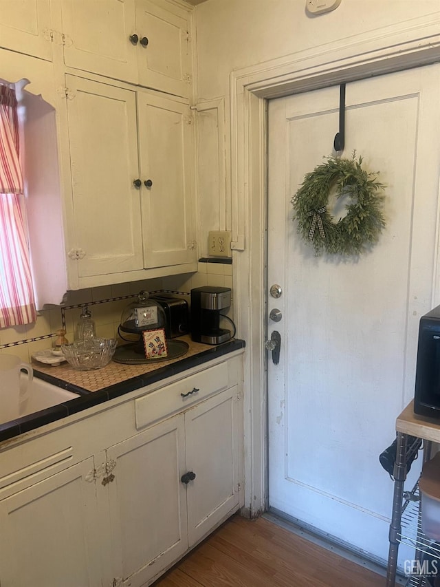 kitchen with dark wood finished floors and white cabinets