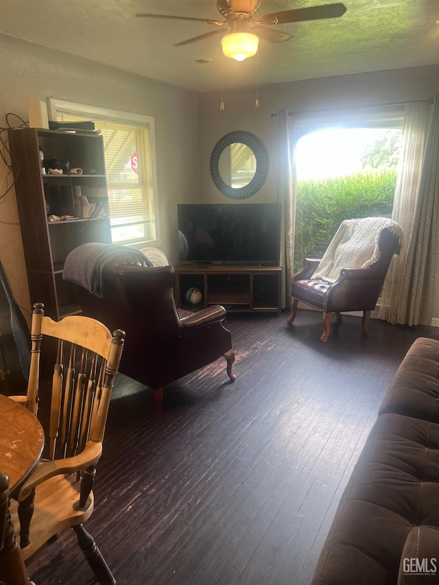 living area with a healthy amount of sunlight, hardwood / wood-style floors, and ceiling fan