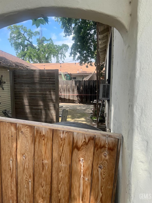 exterior space with cooling unit and fence