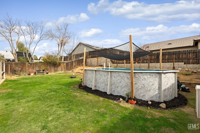 view of yard with a fenced in pool