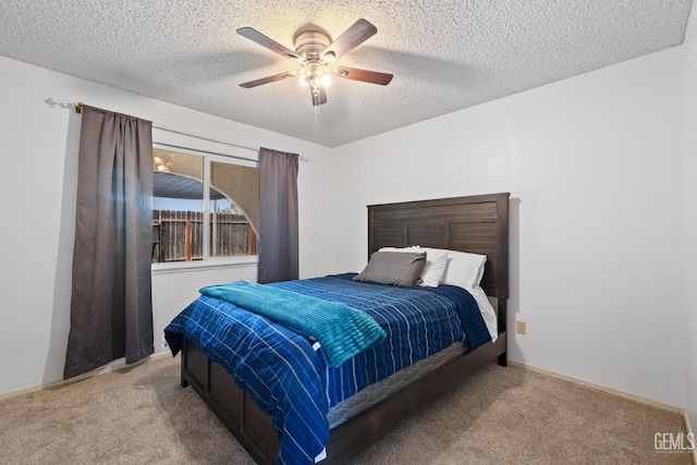 bedroom featuring ceiling fan, light carpet, and a textured ceiling