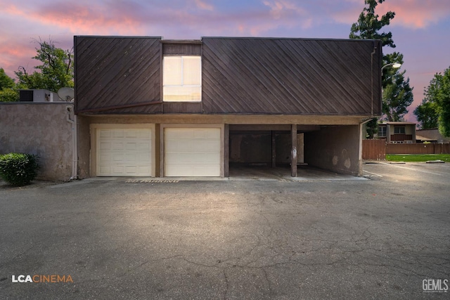 2105 Pinion Springs Cir Unit D, Bakersfield, CA 93309 - garage at dusk featuring fence