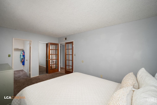 2105 Pinion Springs Cir Unit D, Bakersfield, CA 93309 - bedroom featuring carpet floors, a closet, a textured ceiling, french doors, and a spacious closet