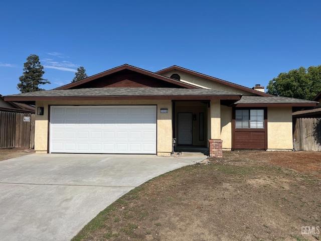 ranch-style house featuring driveway, fence, an attached garage, a shingled roof, and stucco siding