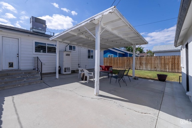 view of patio / terrace featuring fence and central AC unit