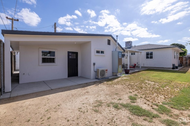 back of property featuring fence, ac unit, stucco siding, central AC unit, and a patio area