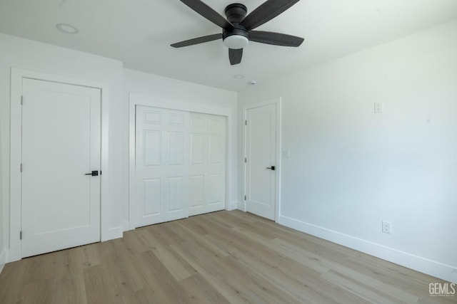 unfurnished bedroom featuring a closet, baseboards, a ceiling fan, and light wood-type flooring