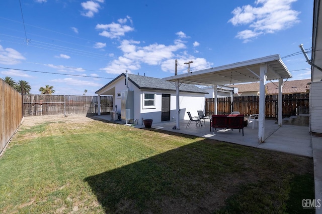 back of property featuring a fenced backyard, a patio, stucco siding, and a yard