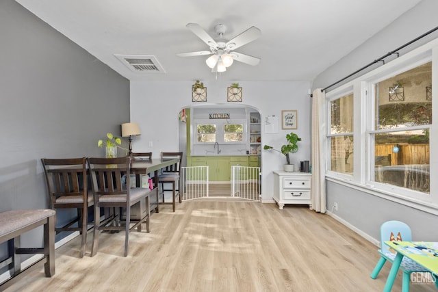339 Ray St, Bakersfield, CA 93308 - dining space with wood finished floors, a ceiling fan, and arched walkways