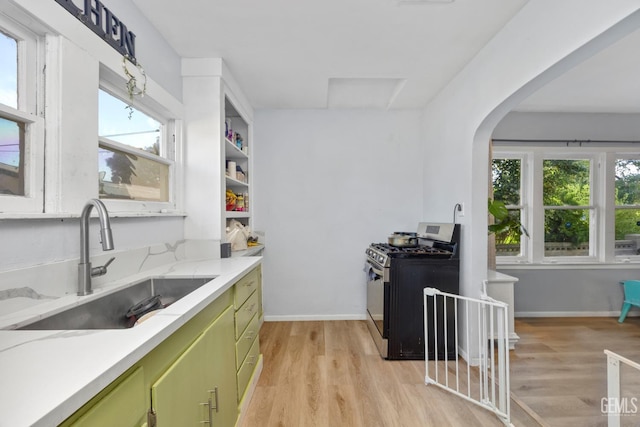 339 Ray St, Bakersfield, CA 93308 - kitchen featuring green cabinetry, gas range, light wood-type flooring, and plenty of natural light