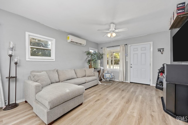 339 Ray St, Bakersfield, CA 93308 - living area featuring a wall mounted AC, a ceiling fan, and light wood-style flooring