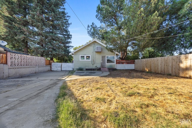 339 Ray St, Bakersfield, CA 93308 - bungalow with an AC wall unit and a gate
