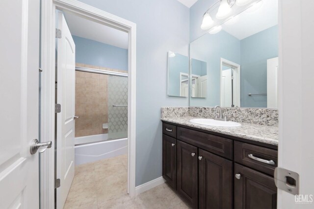 2624 Oakley St, Bakersfield, CA 93311 - full bath featuring vanity, shower / bath combination with glass door, baseboards, and tile patterned flooring