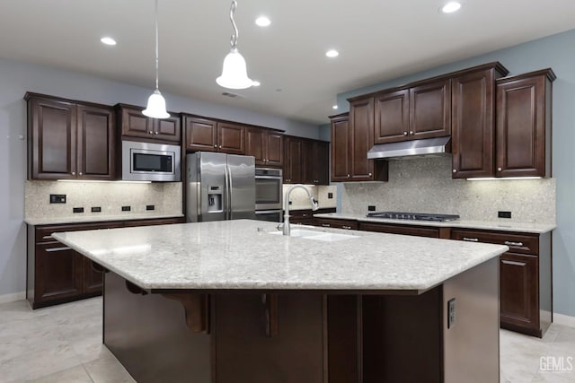 2624 Oakley St, Bakersfield, CA 93311 - kitchen with stainless steel appliances, a sink, under cabinet range hood, dark brown cabinetry, and recessed lighting