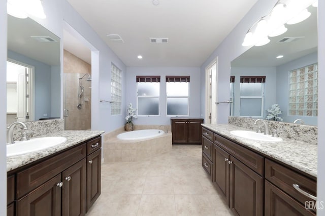 2624 Oakley St, Bakersfield, CA 93311 - bathroom with two vanities, a tile shower, a garden tub, tile patterned flooring, and recessed lighting