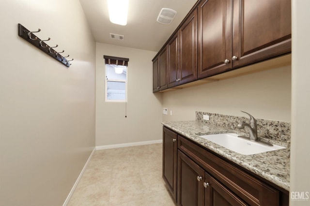 2624 Oakley St, Bakersfield, CA 93311 - washroom featuring cabinet space, hookup for a washing machine, and baseboards