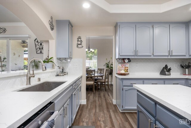 3404 Medallion Rose Ave, Bakersfield, CA 93313 - kitchen with dishwasher, a sink, decorative backsplash, dark wood-type flooring, and light stone counters