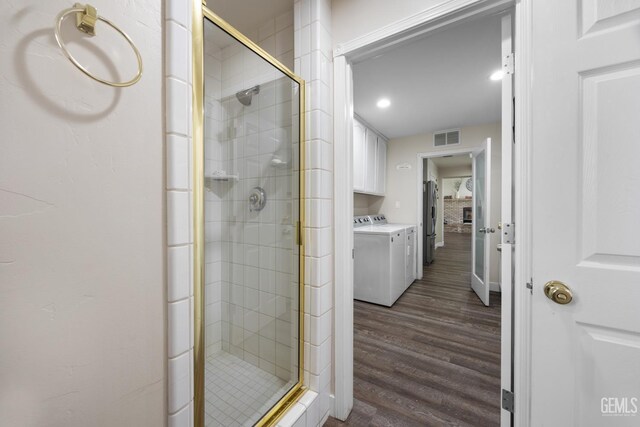 3404 Medallion Rose Ave, Bakersfield, CA 93313 - full bath featuring washing machine and clothes dryer, a stall shower, and wood finished floors