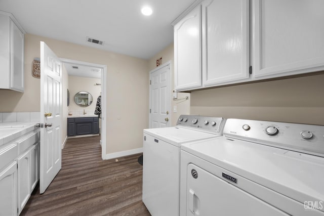 3404 Medallion Rose Ave, Bakersfield, CA 93313 - laundry room with cabinet space, washing machine and dryer, baseboards, and dark wood-style flooring