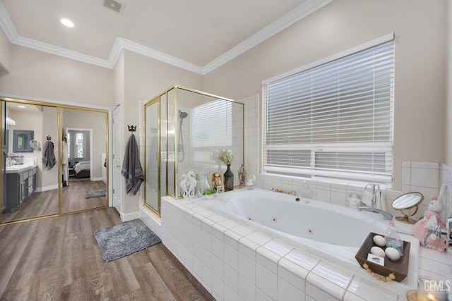 3404 Medallion Rose Ave, Bakersfield, CA 93313 - bathroom with vanity, a shower stall, a whirlpool tub, wood finished floors, and crown molding