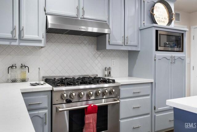 3404 Medallion Rose Ave, Bakersfield, CA 93313 - kitchen with stainless steel appliances, under cabinet range hood, backsplash, and gray cabinets