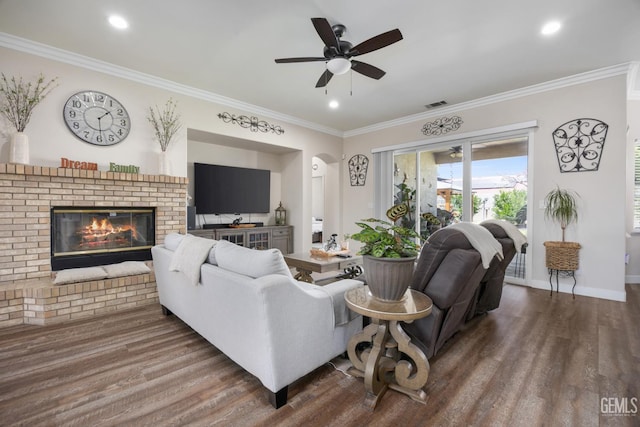 3404 Medallion Rose Ave, Bakersfield, CA 93313 - living room featuring wood finished floors, a fireplace, ornamental molding, ceiling fan, and recessed lighting
