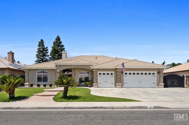 3404 Medallion Rose Ave, Bakersfield, CA 93313 - mediterranean / spanish home featuring a garage, a tile roof, stucco siding, a front lawn, and driveway