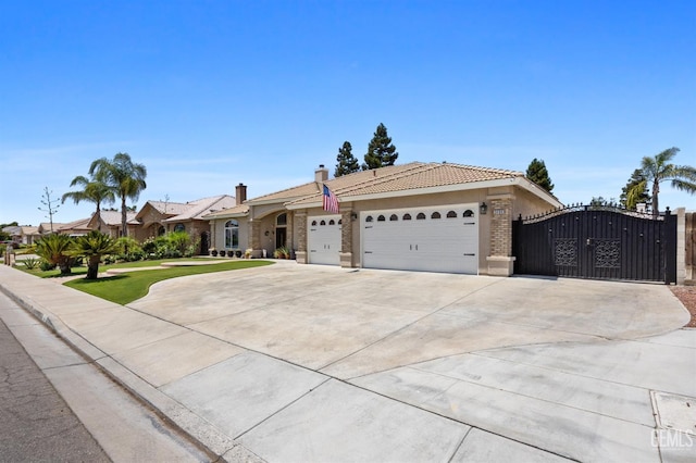 3404 Medallion Rose Ave, Bakersfield, CA 93313 - single story home featuring an attached garage, concrete driveway, a tile roof, a gate, and brick siding