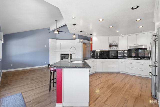 14609 Orchard Crest Ave, Bakersfield, CA 93314 - kitchen with under cabinet range hood, ceiling fan, appliances with stainless steel finishes, tasteful backsplash, and white cabinets