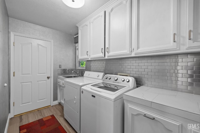 14609 Orchard Crest Ave, Bakersfield, CA 93314 - laundry area with washer and clothes dryer, cabinet space, and light wood-type flooring