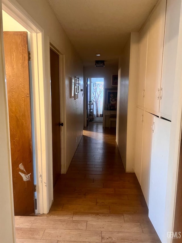 hallway with light hardwood / wood-style floors